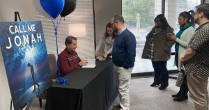 Dr. Quinnan signing his new book