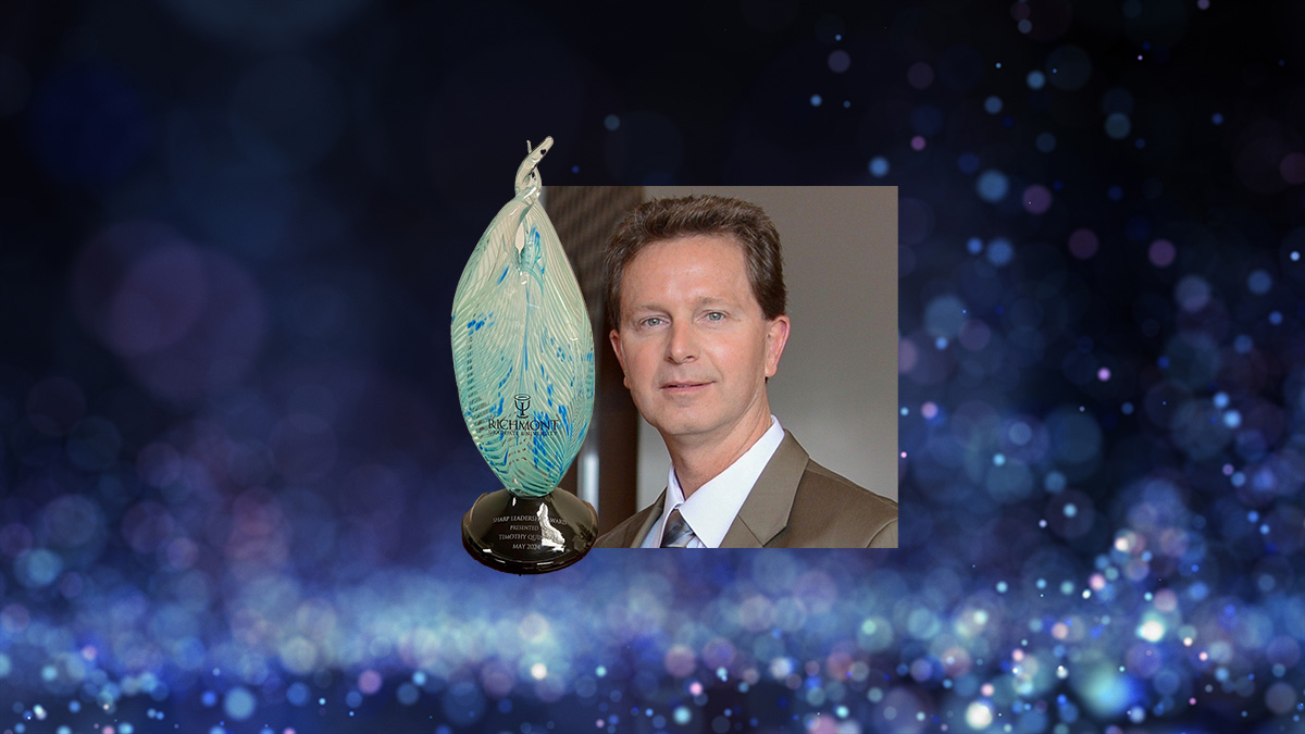 Photo of Dr. Quinnan and the award